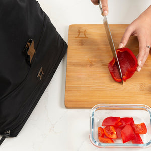 girl chopping red pepper using fancy insulated luxury lunch bag tote dinner meals purse lunch